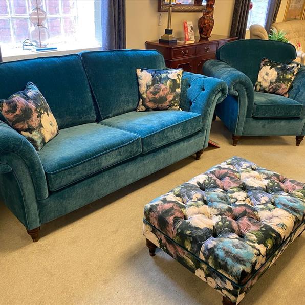 BLUE SOFA CHAIR AND FOOTSTOOL IN SHOWROOM